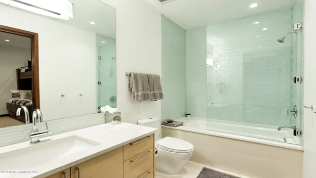 a bathroom with a sink toilet tub and shower