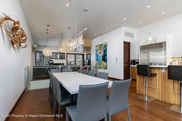 a large kitchen with a table and chairs