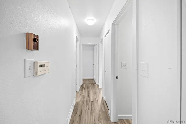 a view of a hallway with wooden floor
