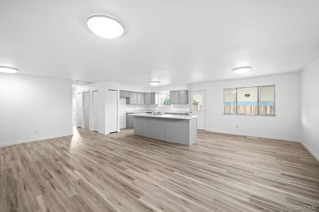 a view of kitchen with wooden floor and window
