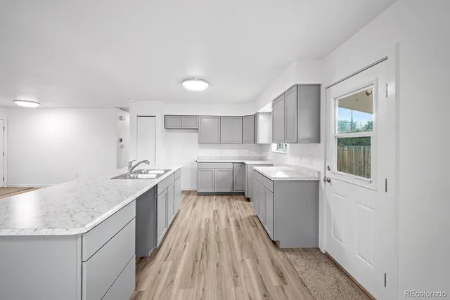 a kitchen with a sink window and cabinets