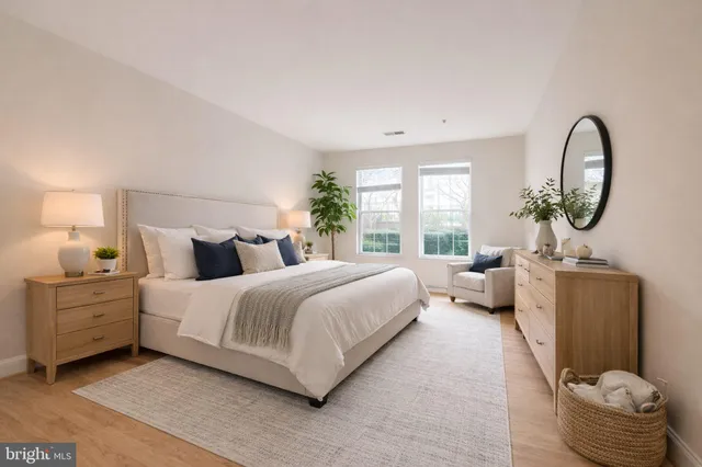 a bed room with a bed and a large window