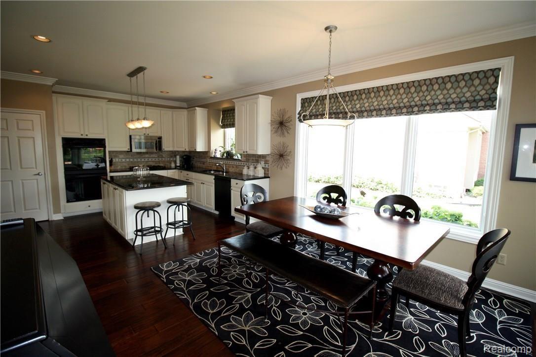 48167 Inveraray Road Canton, MI 48188 - Photo 12 of 37 I spy granite countertops, tile backsplash and eat-in kitchen.