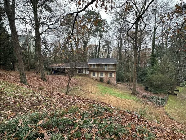 a view of house with backyard and seating area