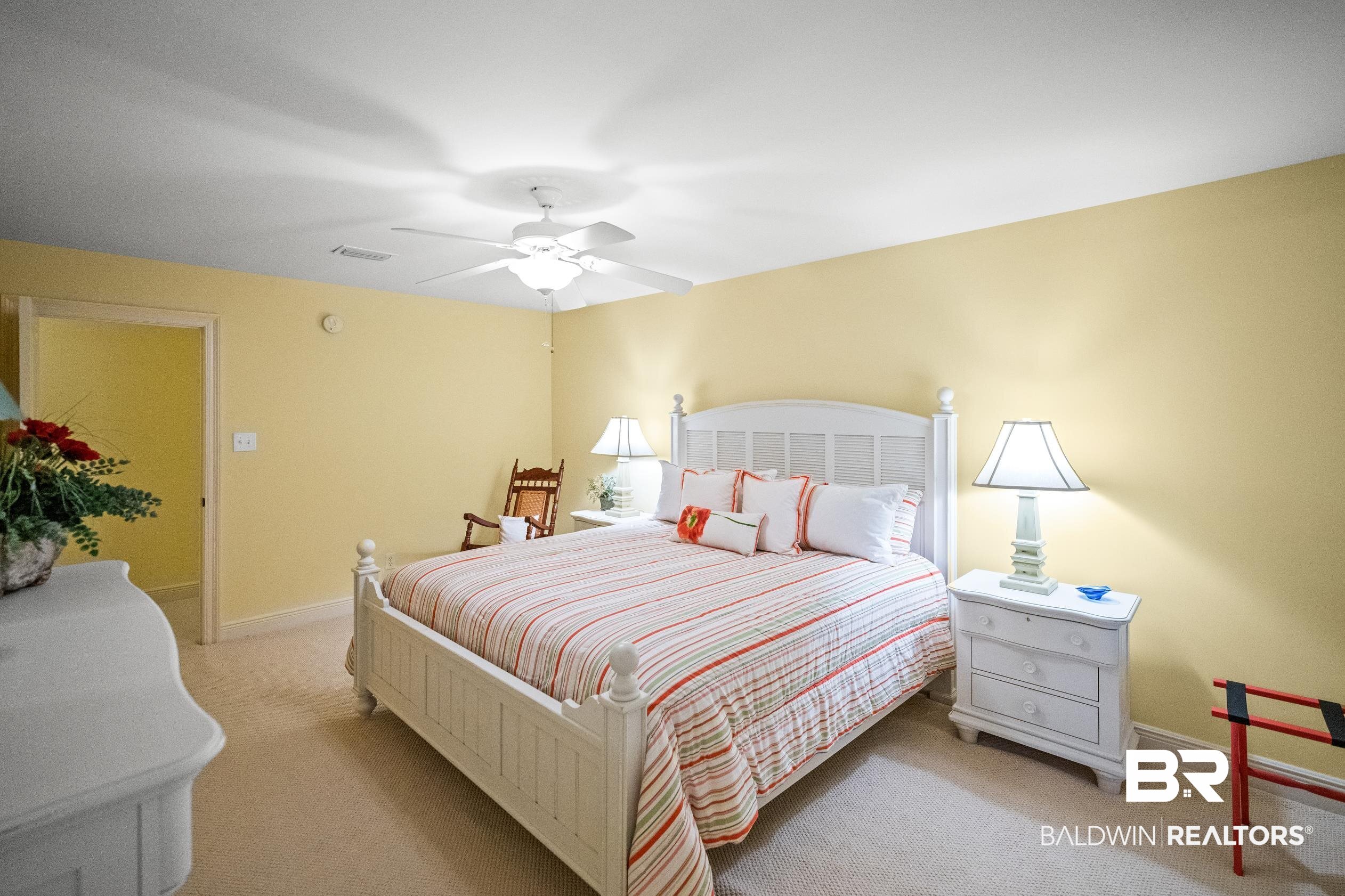 404 Peninsula Boulevard Gulf Shores, AL 36542 - Photo 16 of 51 Bedroom featuring light colored carpet and a ceiling fan