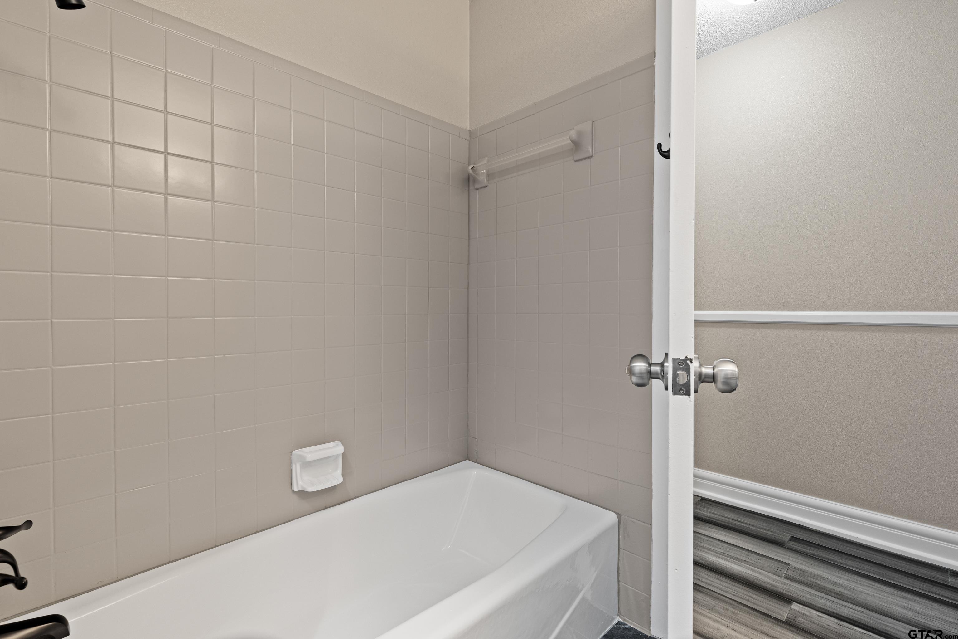 1821 Azalea Street Gilmer, TX 75644 - Photo 22 of 34 a bathroom with a bathtub