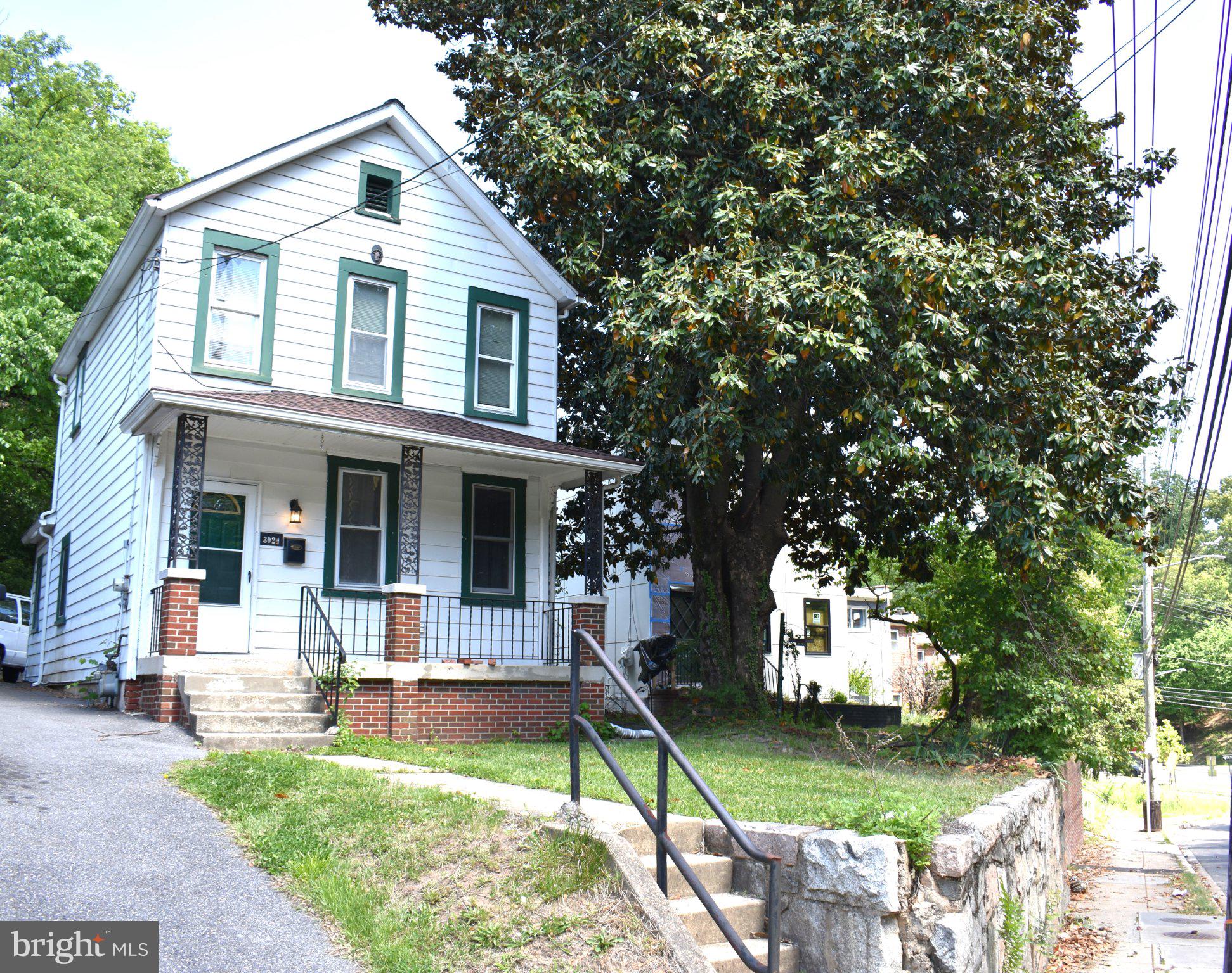 3024 Stanton Road Southeast Washington, DC 20020 - Photo 13 of 13 a front view of a house with a yard table and chairs