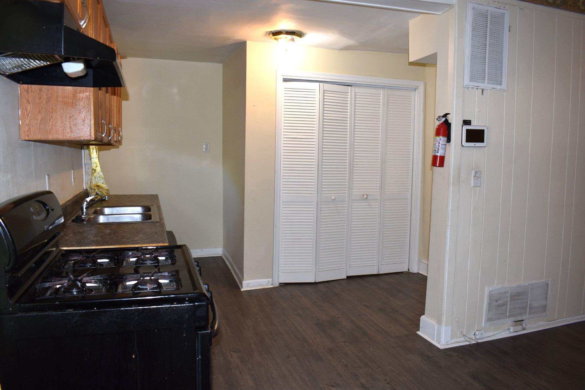 3024 Stanton Road Southeast Washington, DC 20020 - Photo 6 of 13 a kitchen with a stove and a wooden floor