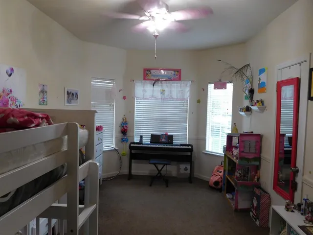 a room that has a bed and a bookshelf in it