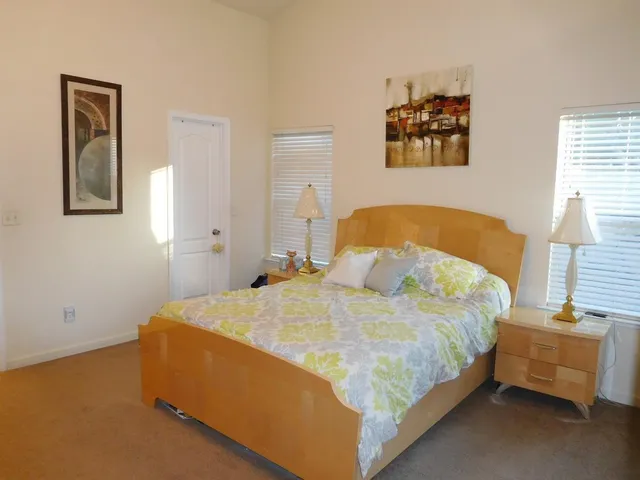 a bedroom with bed and a window