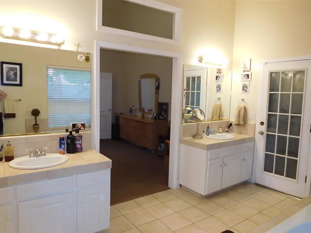 a bathroom with a double vanity sink and mirror