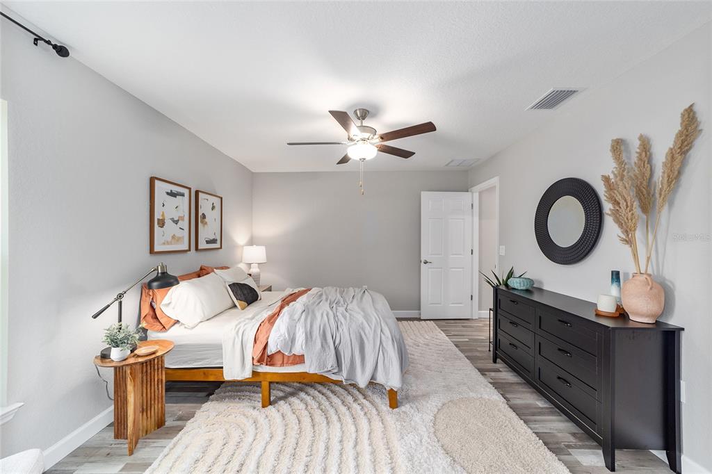 8571 Southwest 131st Place Ocala, FL 34473 - Photo 20 of 32 a bedroom with a bed and wooden floor