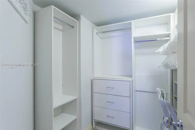 a bathroom with a granite countertop sink a mirror and a bathtub