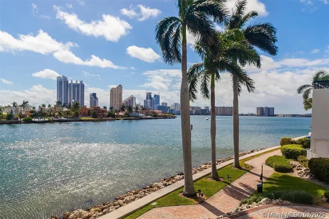a view of a lake with boats and trees in the background