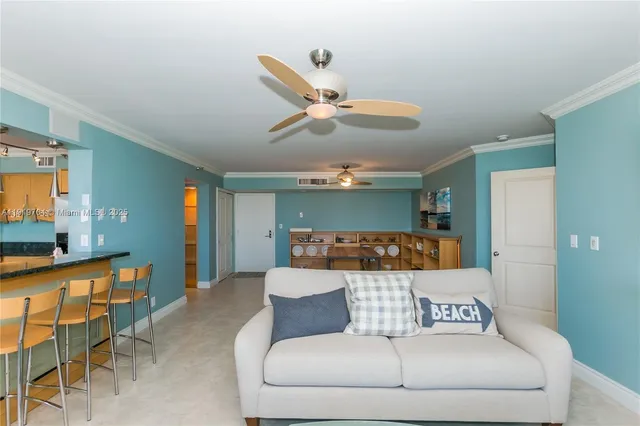 a living room with furniture and a ceiling fan