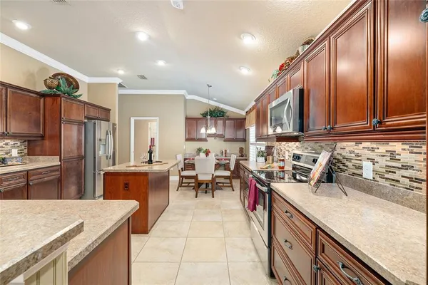 a kitchen with stainless steel appliances granite countertop sink stove top oven and cabinets