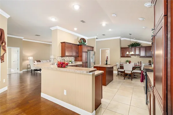 a view of living room with furniture and a kitchen