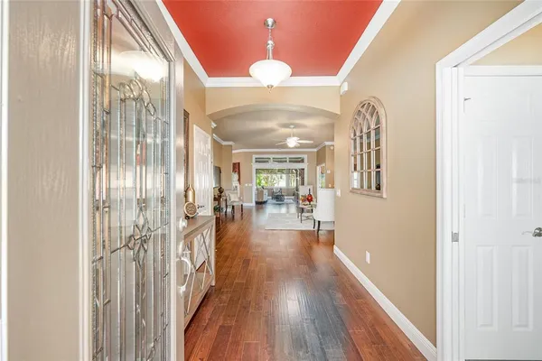 a view of a hallway with wooden floor fireplace and dining room