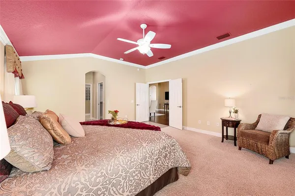a bedroom with a bed and a chandelier
