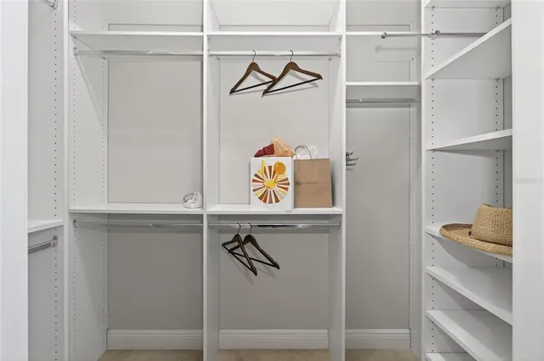 a room with walk in closet and window