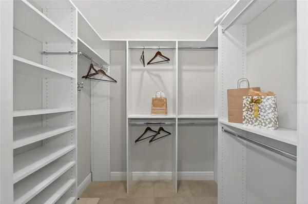 a spacious bedroom with a bed and a window