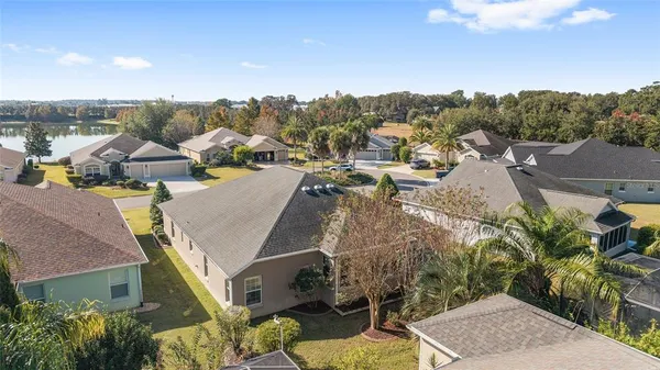 a view of a house with backyard and a tree
