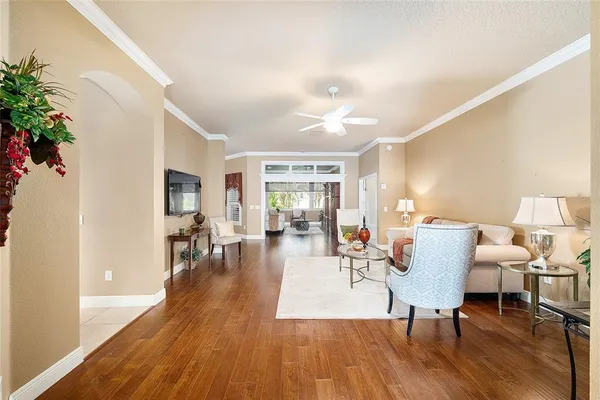 a living room with furniture and wooden floor