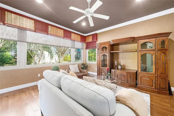 a living room with furniture and large windows