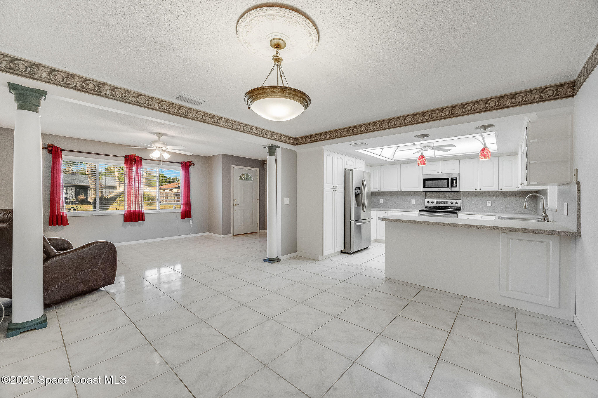987 Sycamore Drive Rockledge, FL 32955 - Photo 11 of 48 a kitchen with stainless steel appliances granite countertop a sink and cabinets