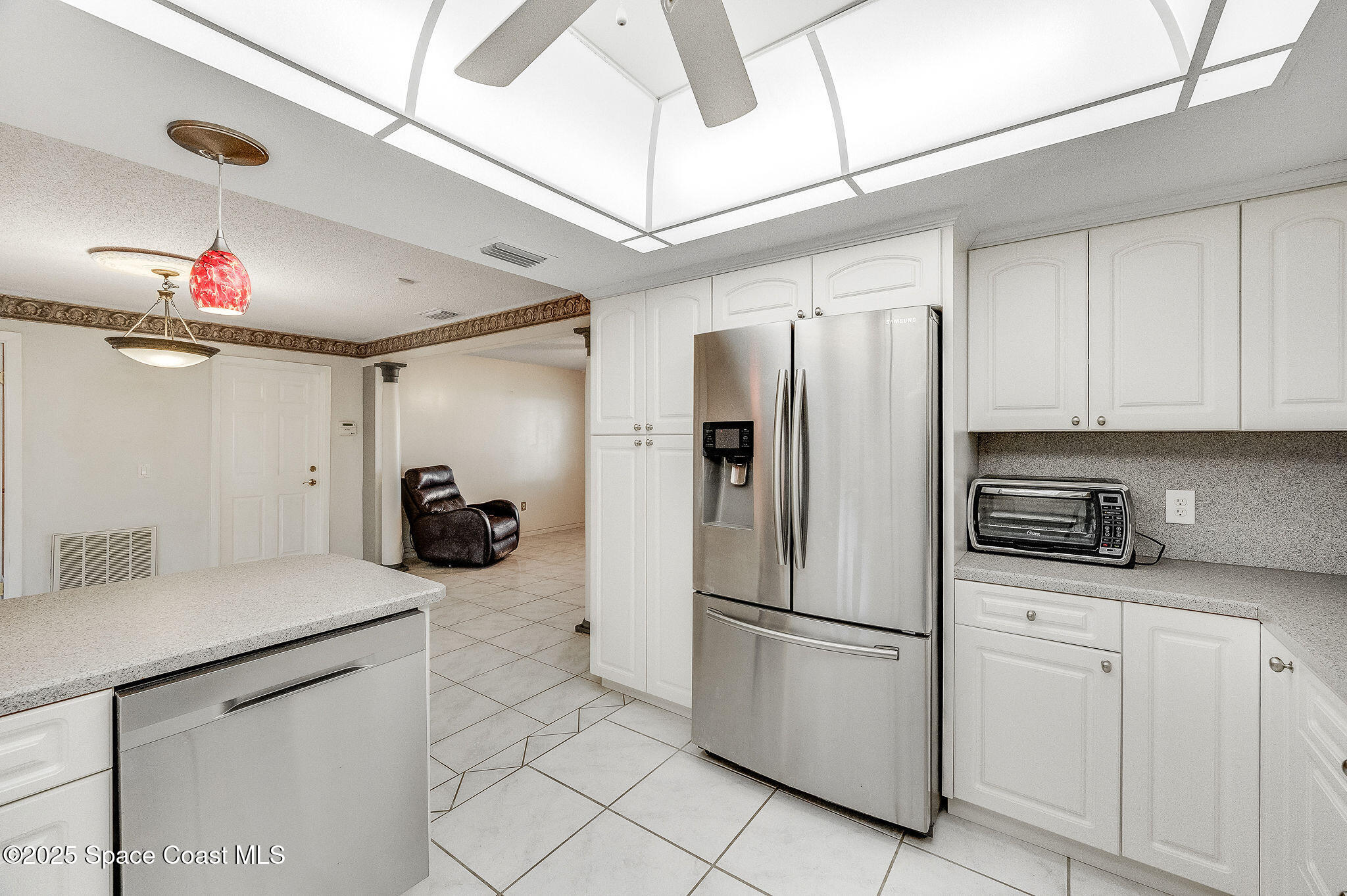 987 Sycamore Drive Rockledge, FL 32955 - Photo 17 of 48 a kitchen with stainless steel appliances a refrigerator sink and cabinets