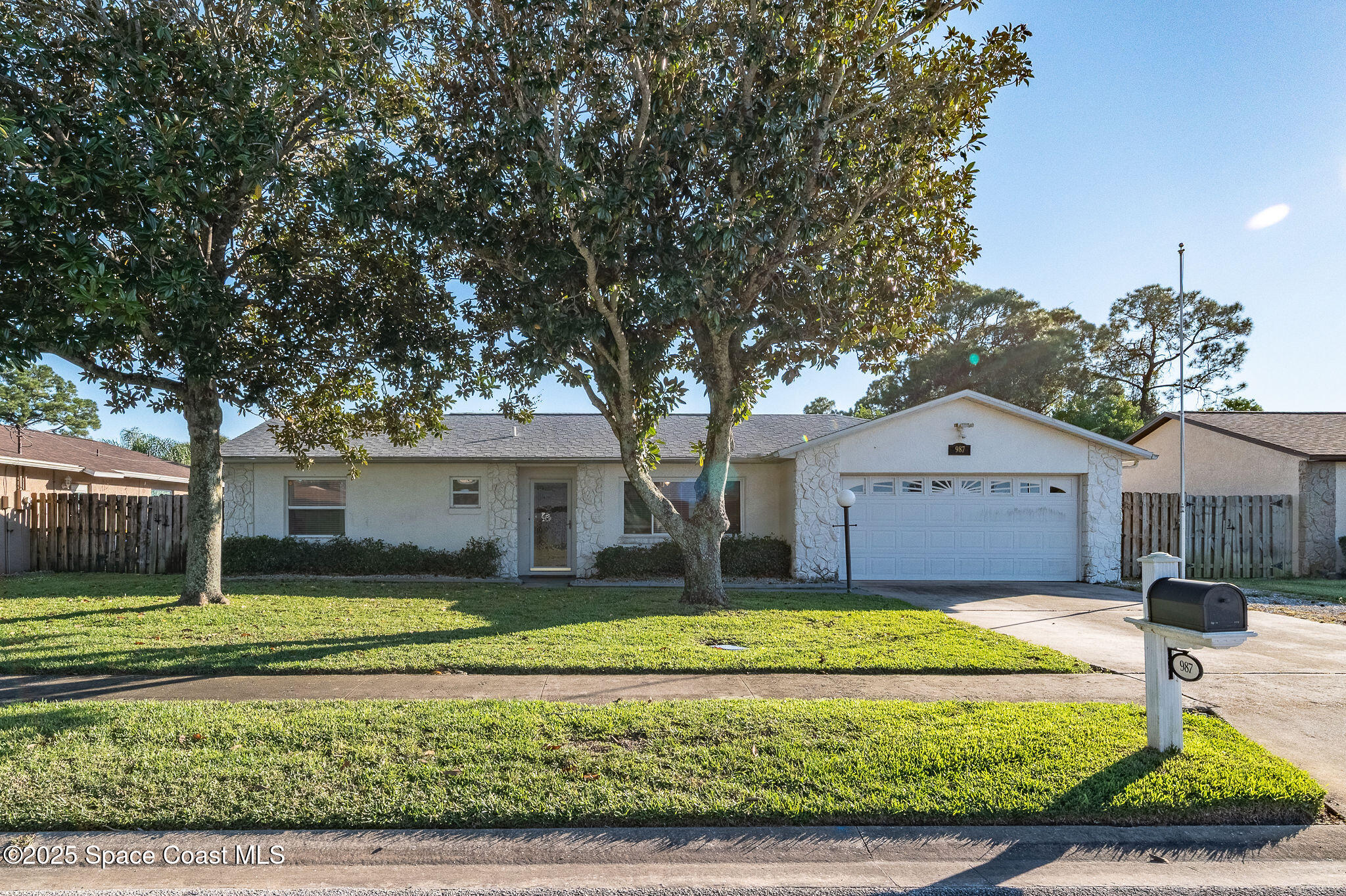 987 Sycamore Drive Rockledge, FL 32955 - Photo 2 of 48 a front view of a house with a yard