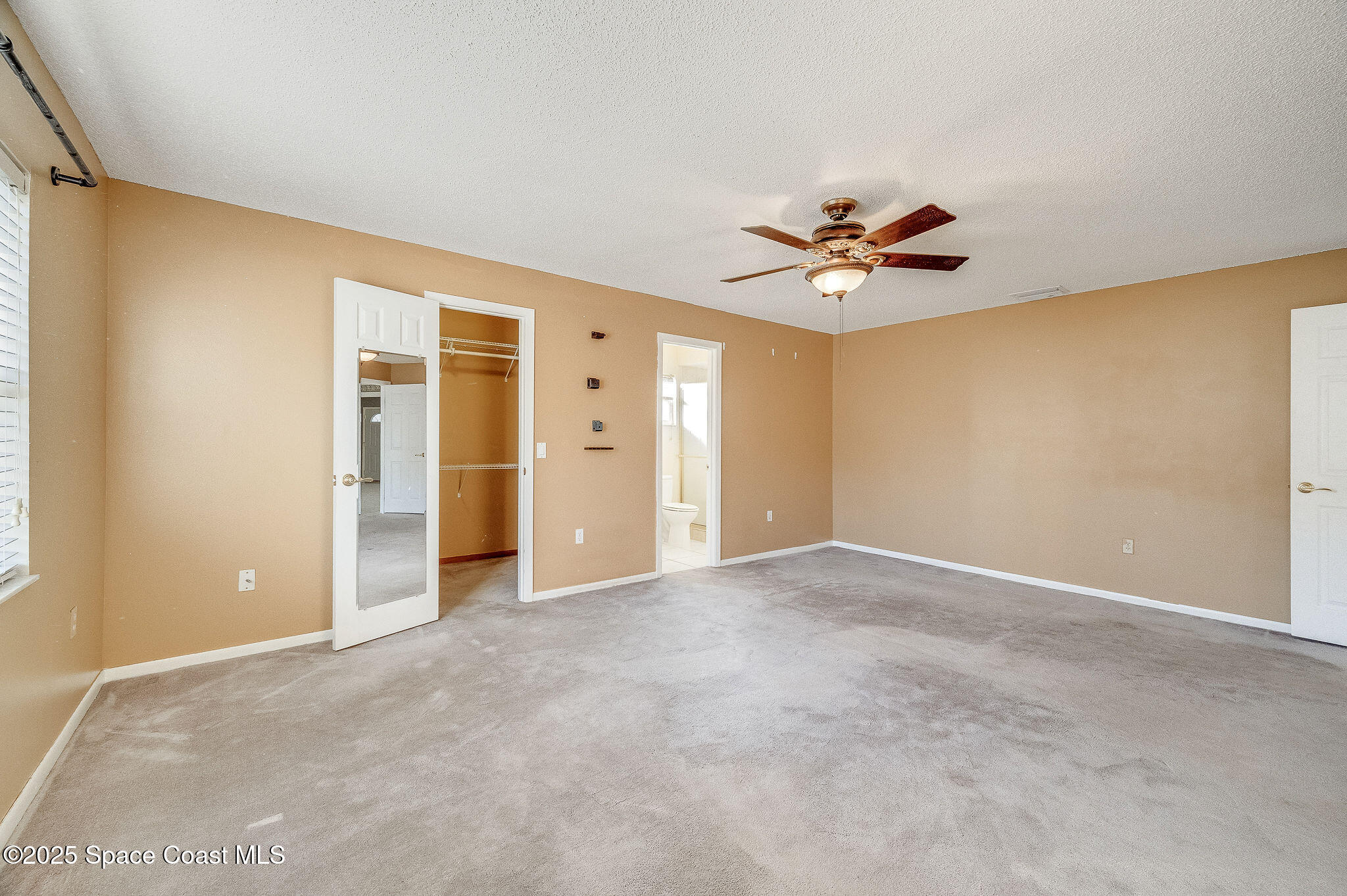 987 Sycamore Drive Rockledge, FL 32955 - Photo 22 of 48 an empty room with ceiling fan and window