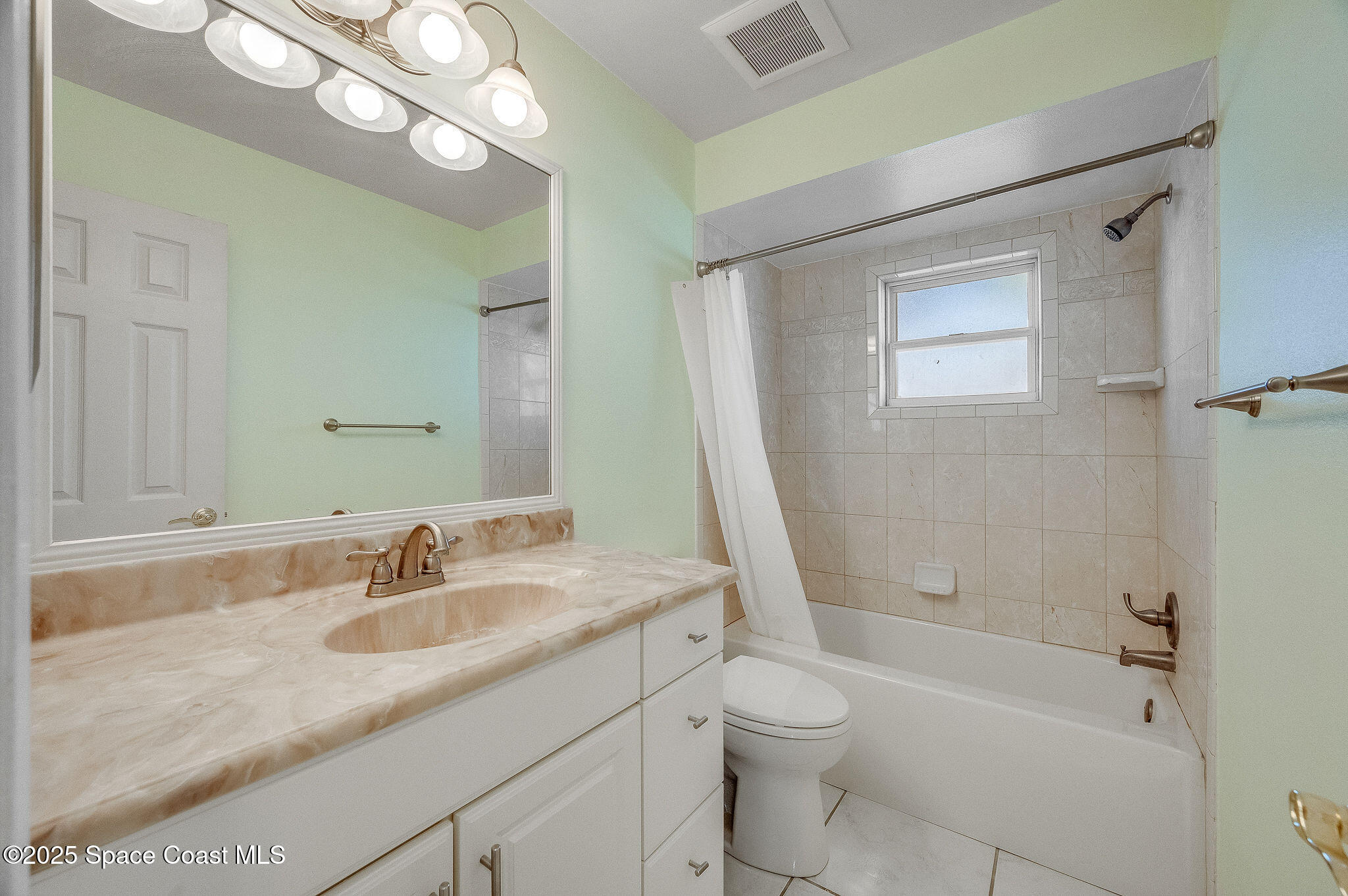 987 Sycamore Drive Rockledge, FL 32955 - Photo 28 of 48 a bathroom with a granite countertop sink a toilet and bathtub