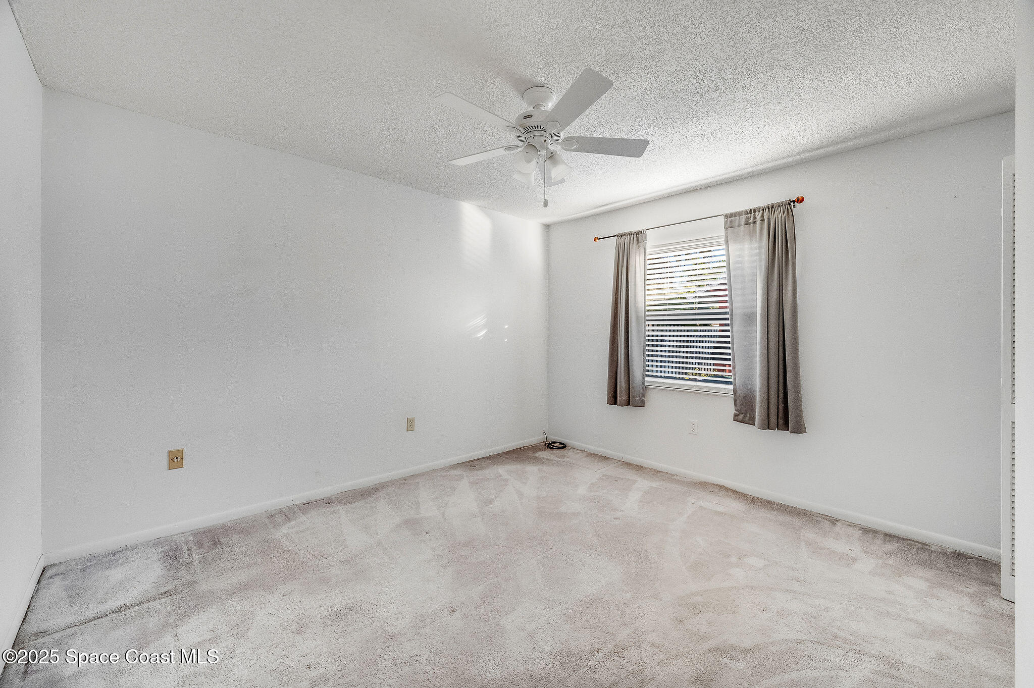 987 Sycamore Drive Rockledge, FL 32955 - Photo 29 of 48 an empty room with windows and fan