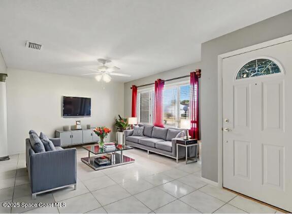 987 Sycamore Drive Rockledge, FL 32955 - Photo 3 of 48 a living room with furniture and a flat screen tv