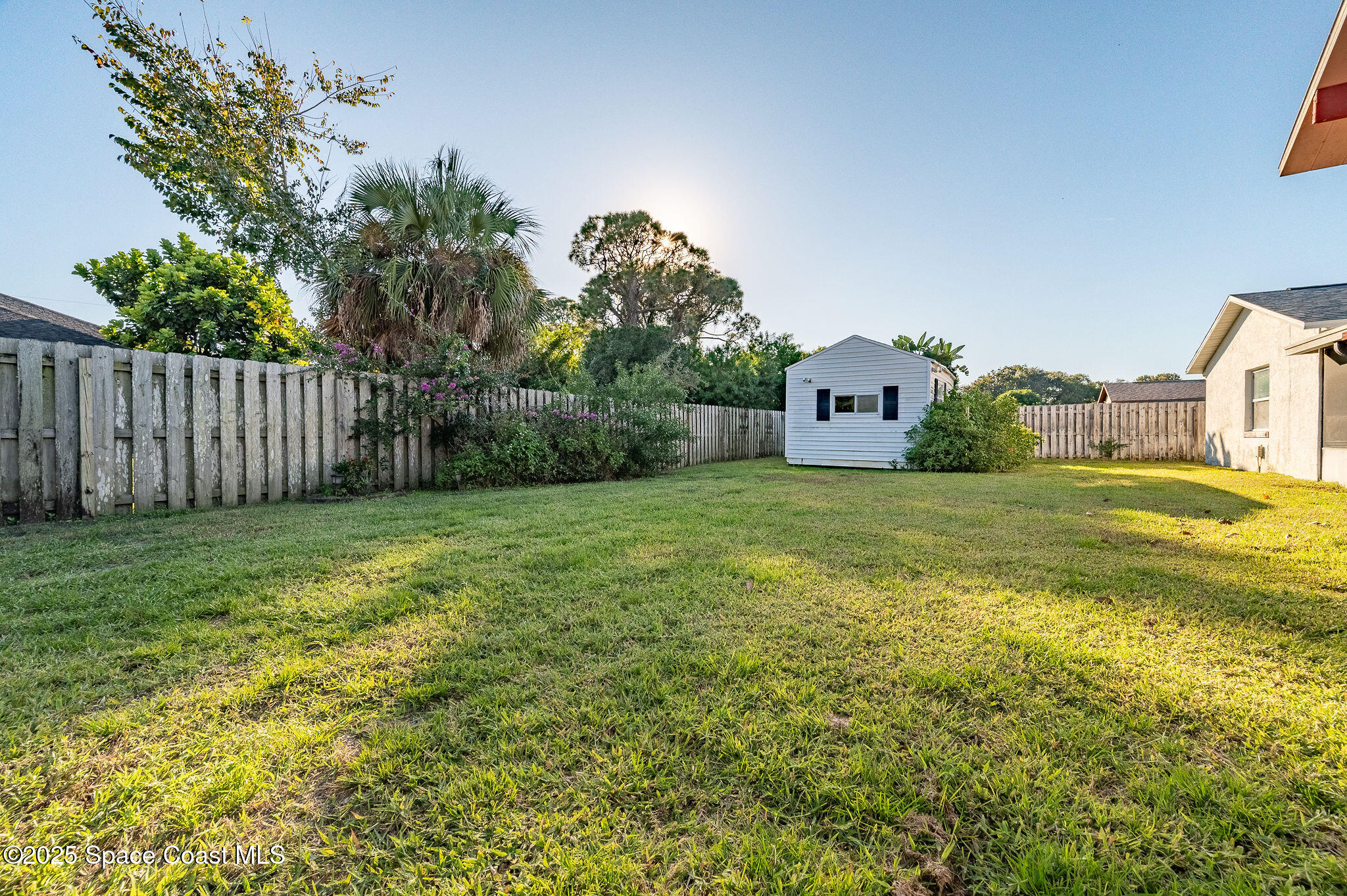 987 Sycamore Drive Rockledge, FL 32955 - Photo 36 of 48 a view of a big yard with large trees and wooden fence