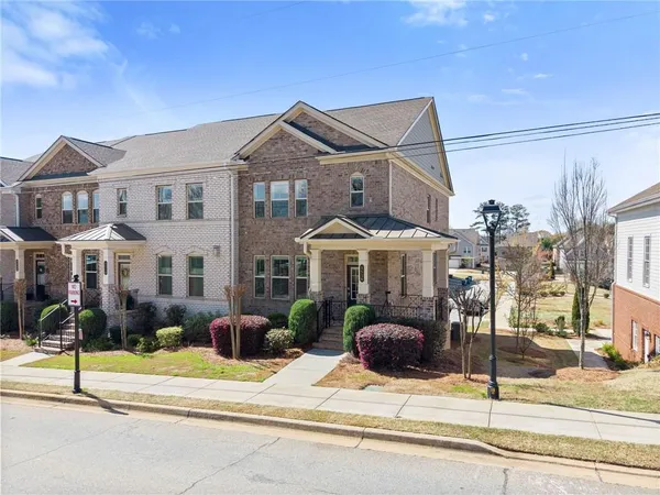 a front view of a house with a garden