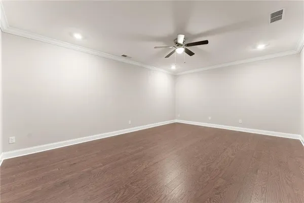 a bathroom with a granite countertop toilet and sink