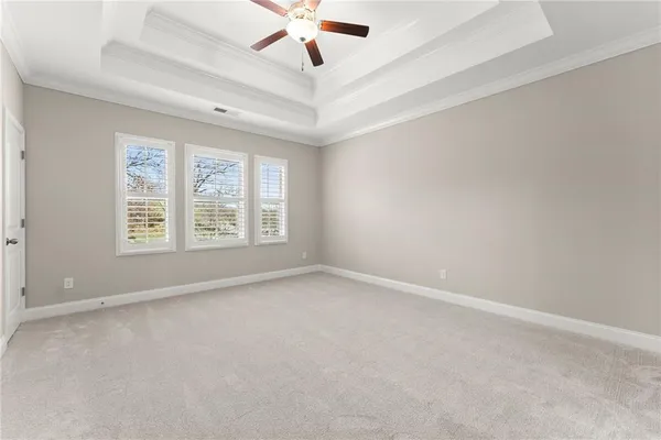 a view of an empty room and kitchen view