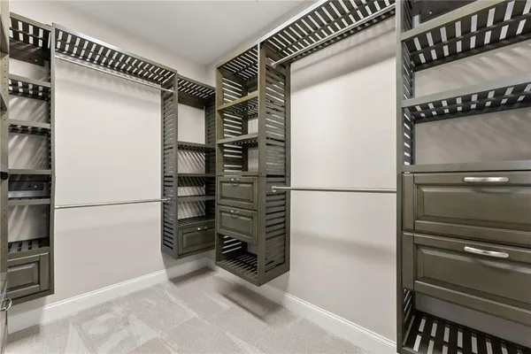 an empty room with chandelier fan