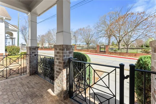 a view of a livingroom with a fireplace a ceiling fan and windows
