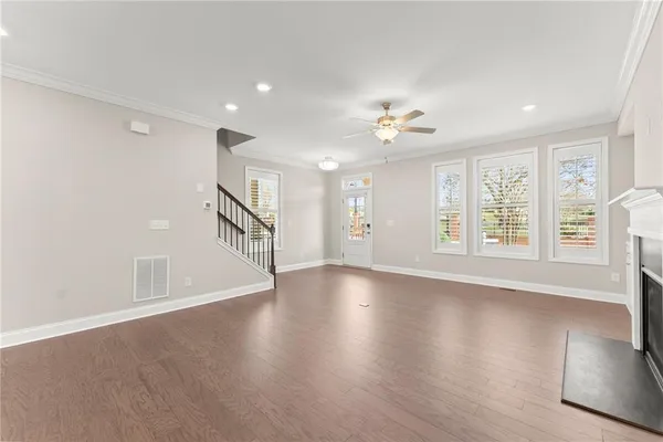 a large kitchen with a large counter top a sink stainless steel appliances and cabinets