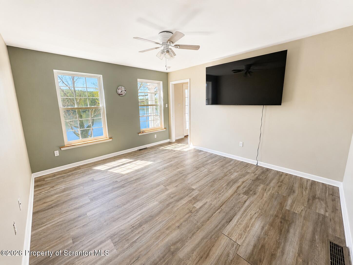 155 Baylor Road Nicholson, PA 18446 - Photo 35 of 53 a view of an empty room with wooden floor and a flat screen tv