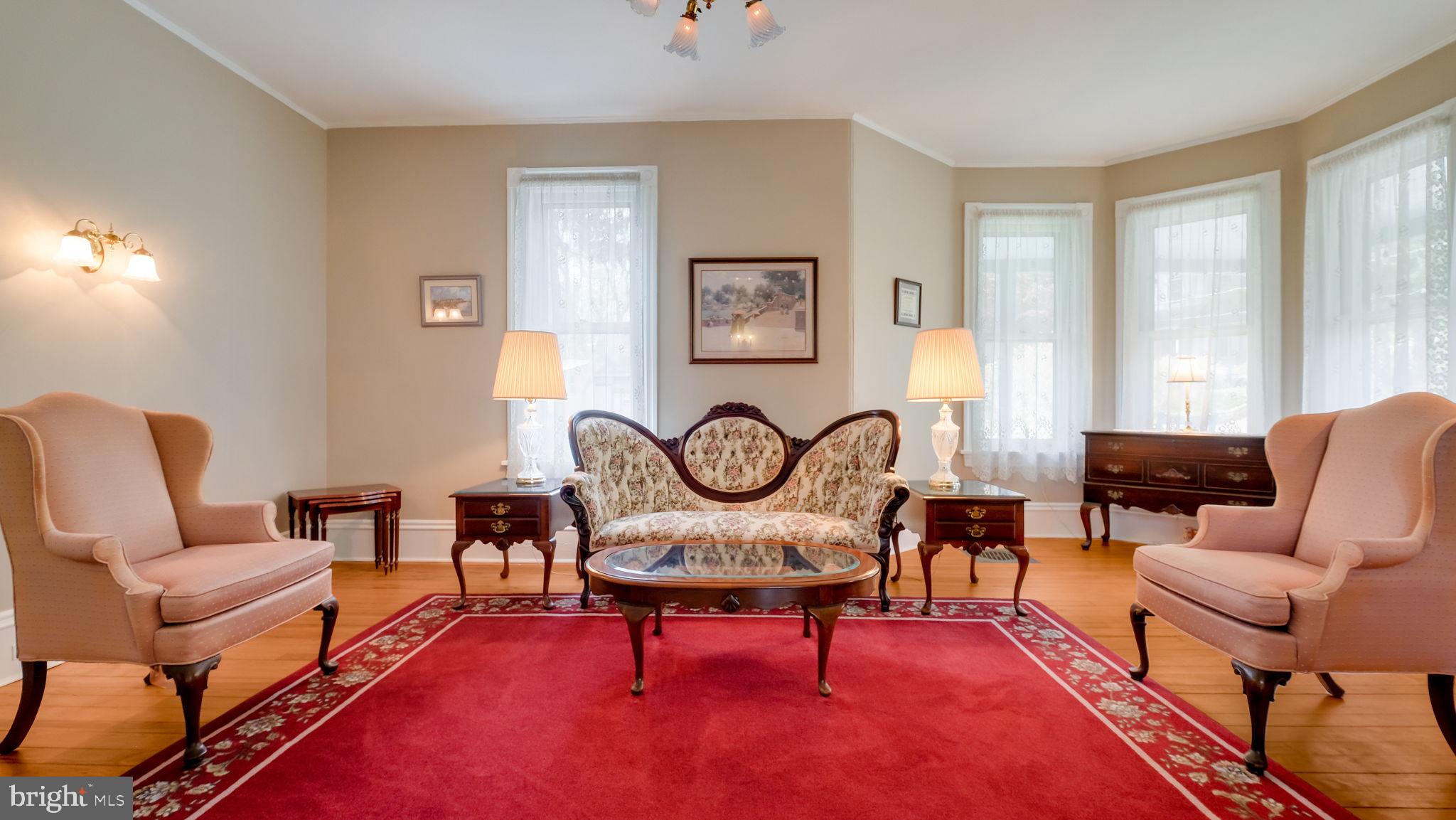 130 Woodland Road Wyncote, PA 19095 - Photo 31 of 37 a living room with furniture a rug and a large window