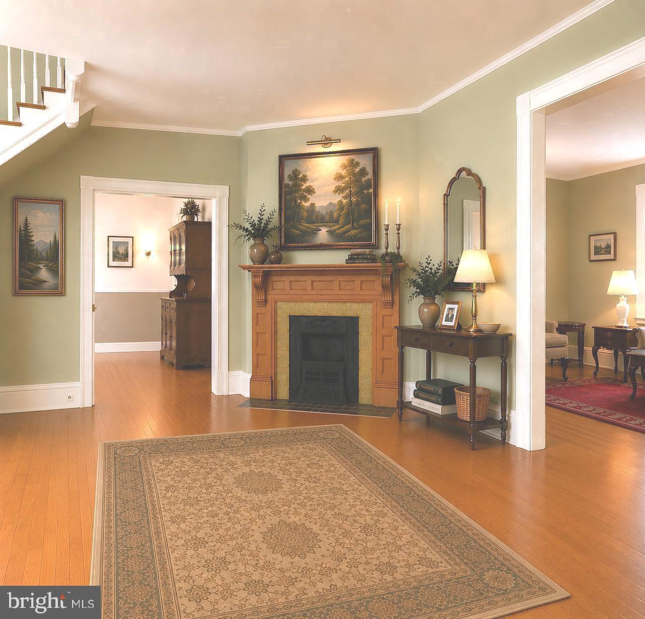 130 Woodland Road Wyncote, PA 19095 - Photo 4 of 37 a view of a livingroom with wooden floor and a fireplace