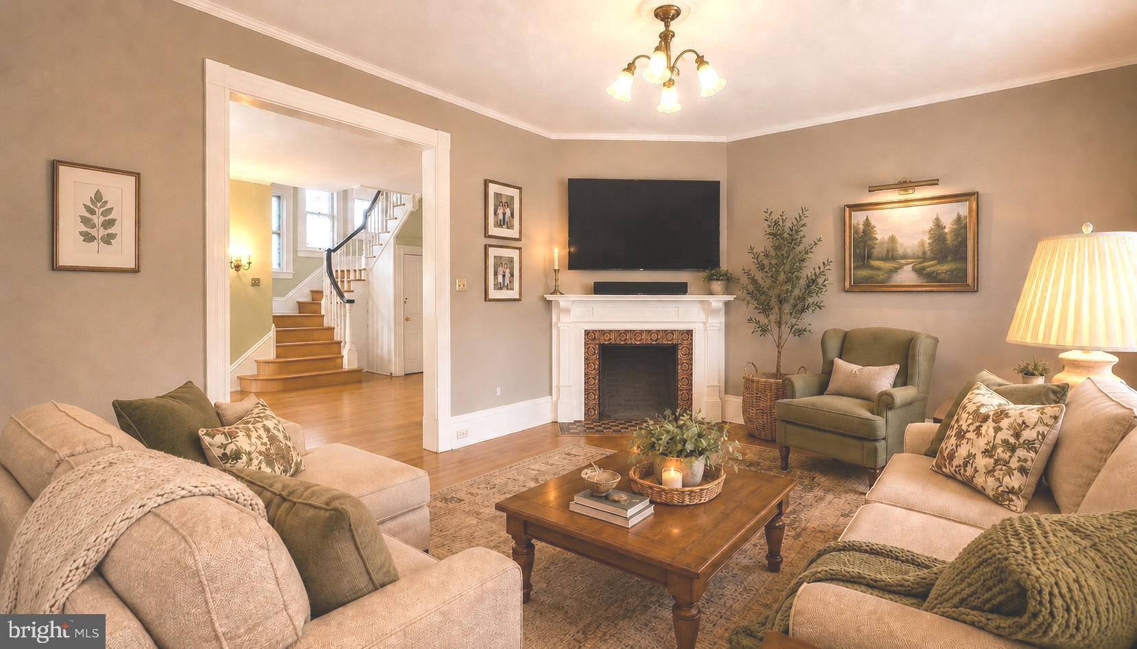 130 Woodland Road Wyncote, PA 19095 - Photo 5 of 37 a living room with furniture a fireplace and a flat screen tv