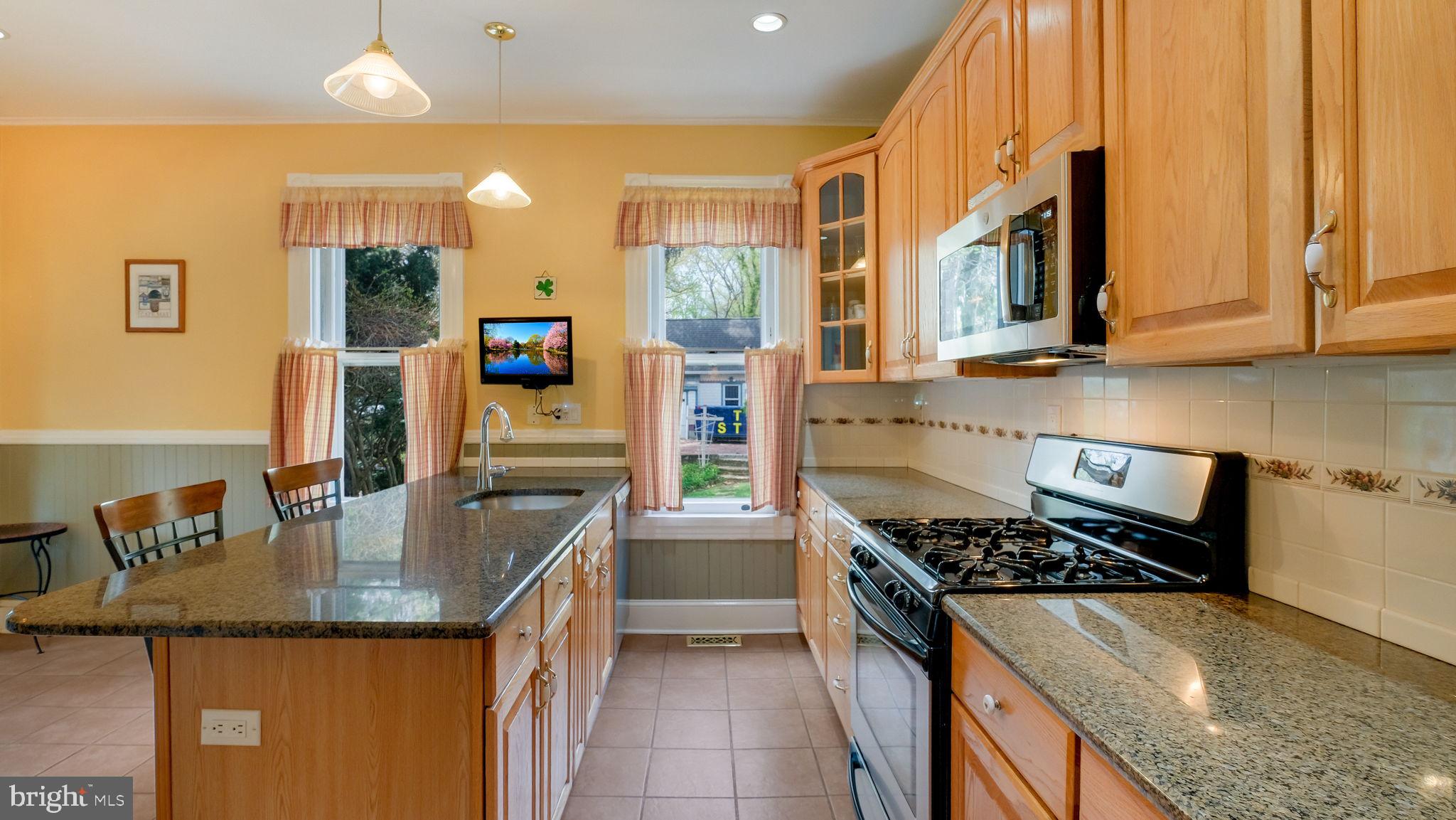130 Woodland Road Wyncote, PA 19095 - Photo 8 of 37 a kitchen with granite countertop a stove and a sink