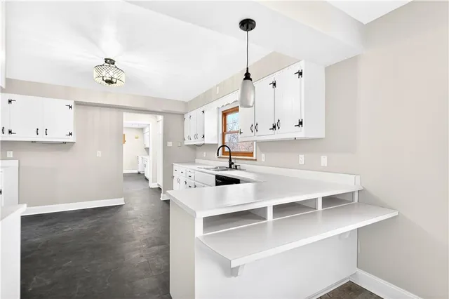 a kitchen with stainless steel appliances a sink a stove a refrigerator and cabinets