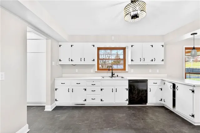 a kitchen with granite countertop a stove and a sink