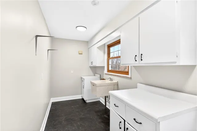 a view of a kitchen with white cabinets and white appliances